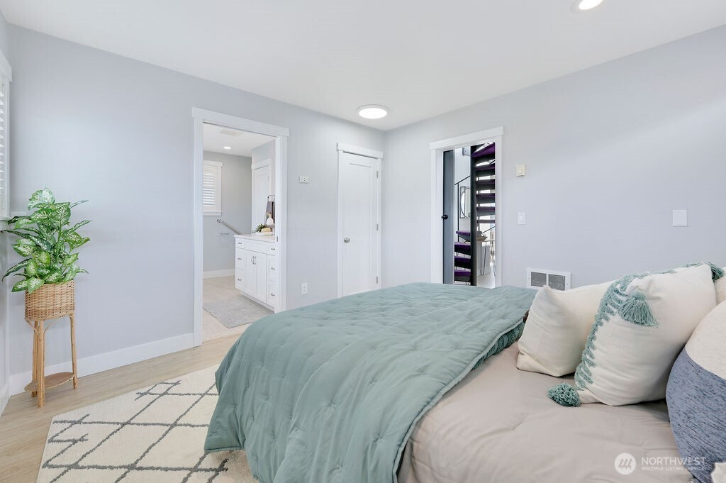 950 Beckett Point Road Port Townsend, WA 98368 - Photo 13 of 37 a bedroom with a bed and a potted plant