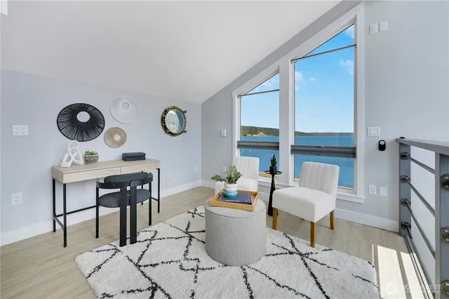 a living room with patio furniture and a wooden floor