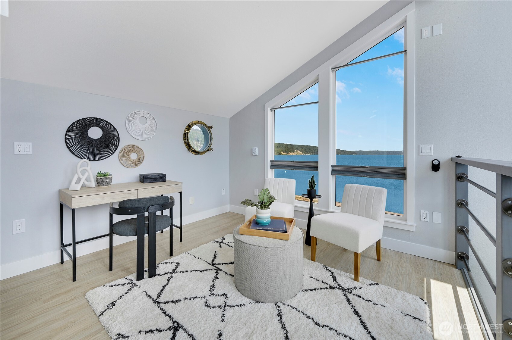 950 Beckett Point Road Port Townsend, WA 98368 - Photo 17 of 37 a living room with patio furniture and a wooden floor