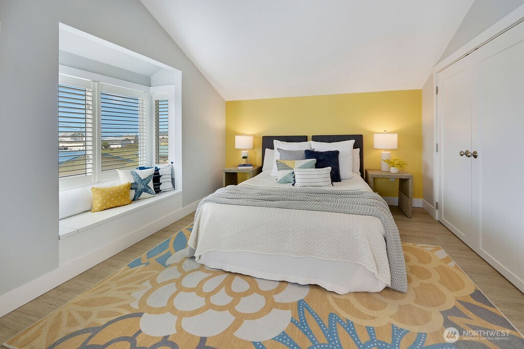 950 Beckett Point Road Port Townsend, WA 98368 - Photo 21 of 37 a bedroom with a bed and wooden floor