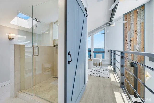 a bathroom with a glass shower door and a glass door