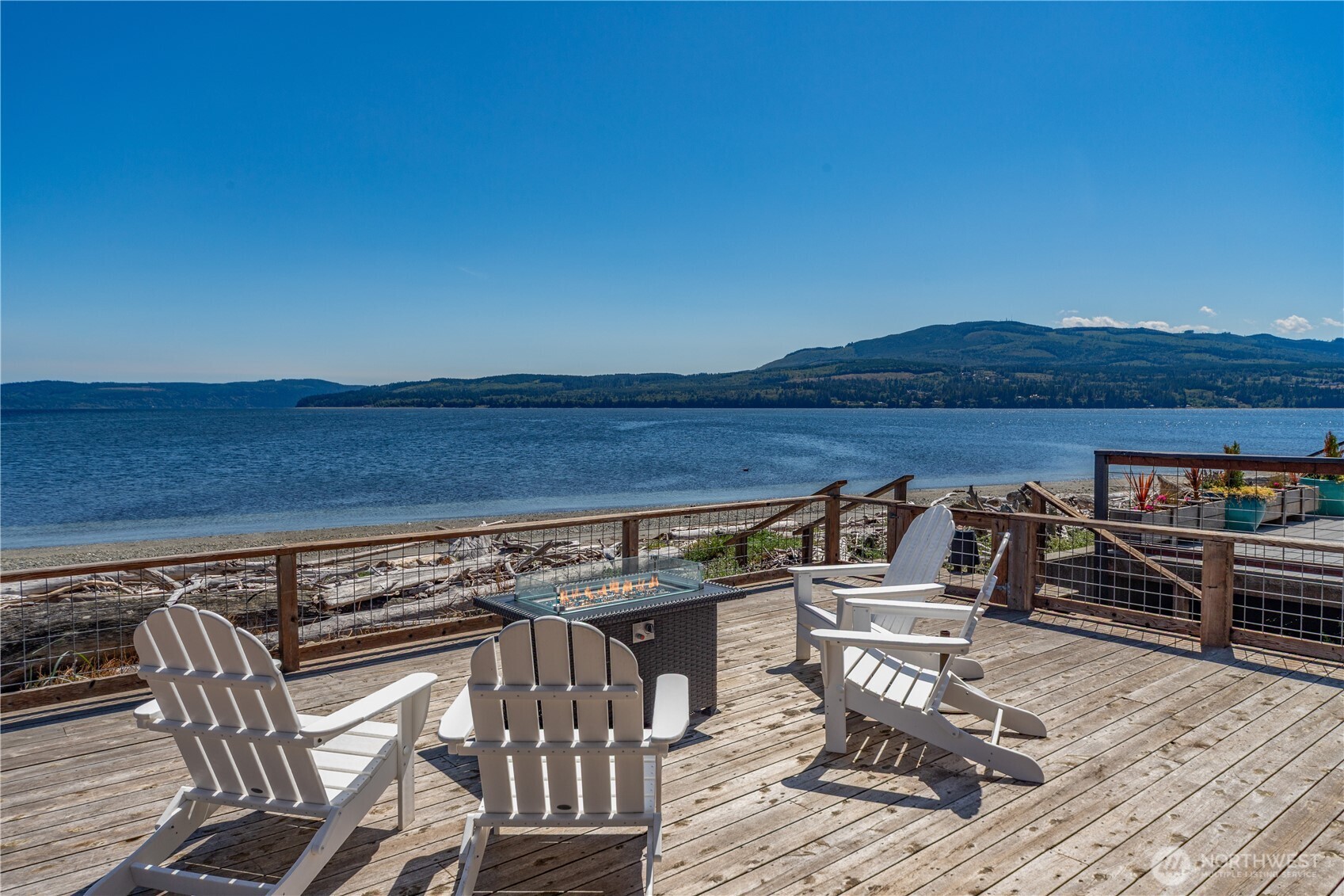950 Beckett Point Road Port Townsend, WA 98368 - Photo 28 of 37 a view of a patio with table and chairs a barbeque with wooden floor and fence