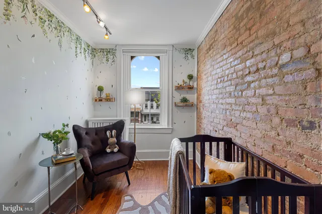 a bed sitting in a bedroom next to a lamp