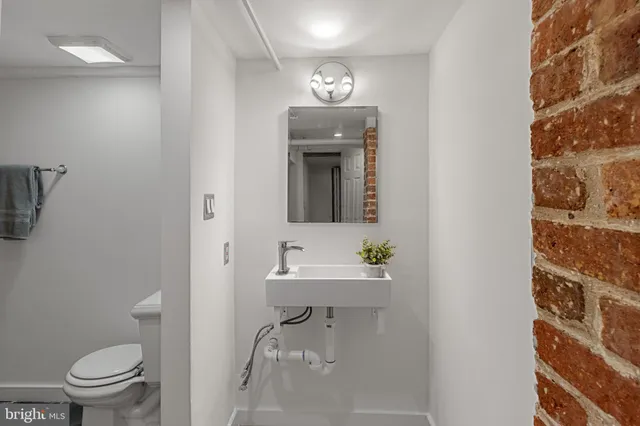 a white toilet sitting next to a shower