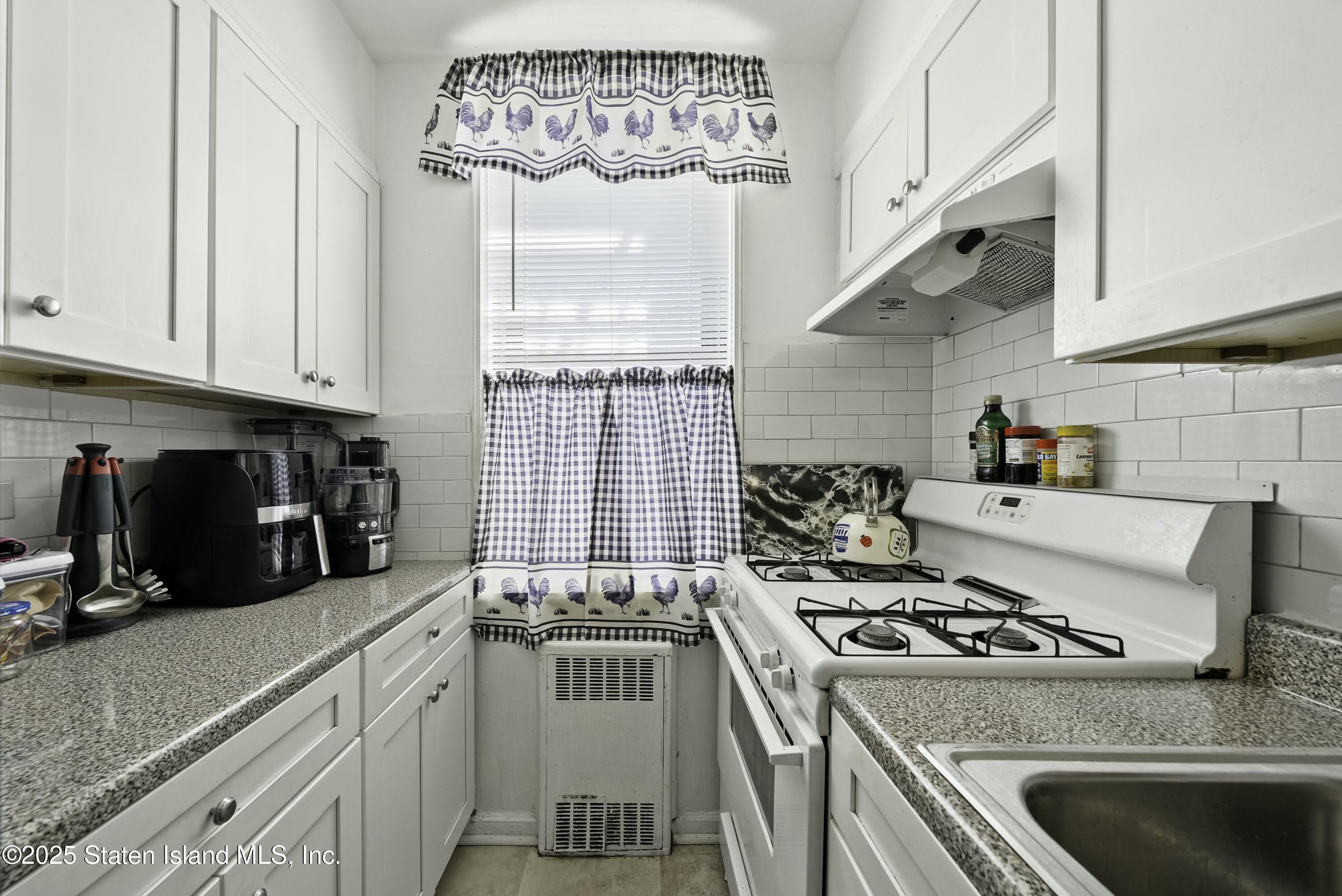 3105 Ave V, Unit 1F Brooklyn, NY 11229 - Photo 8 of 19 a kitchen with a stove a sink and cabinets