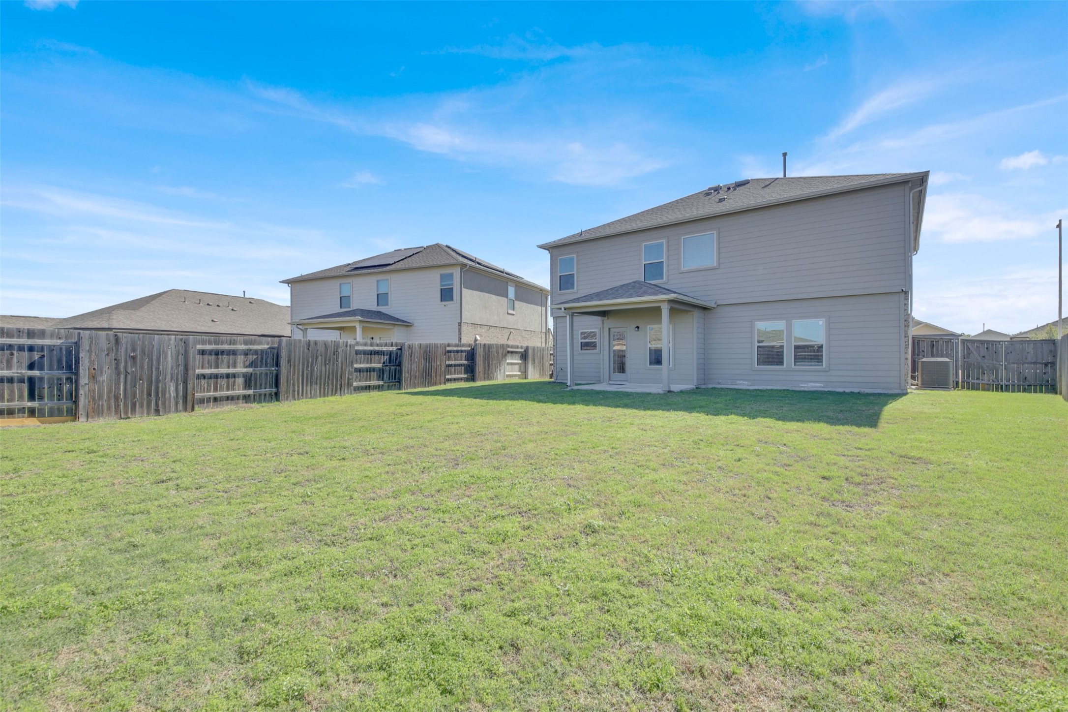 13716 Sugar Bush Path Manor, TX 78653 - Photo 8 of 37 Rear view of property with a fenced backyard and a patio