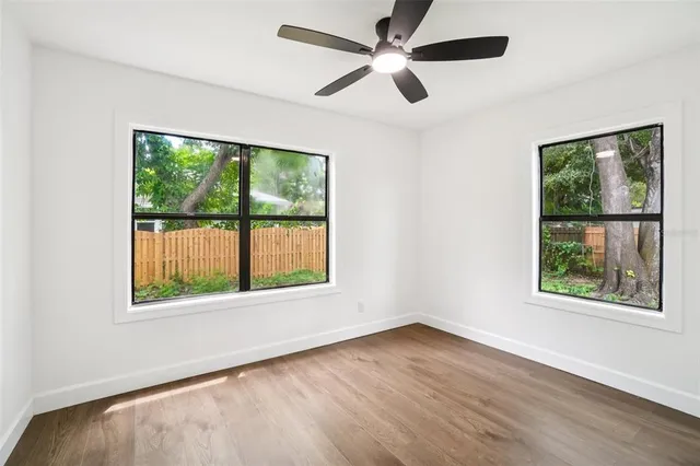 wooden floor in an empty room with a window