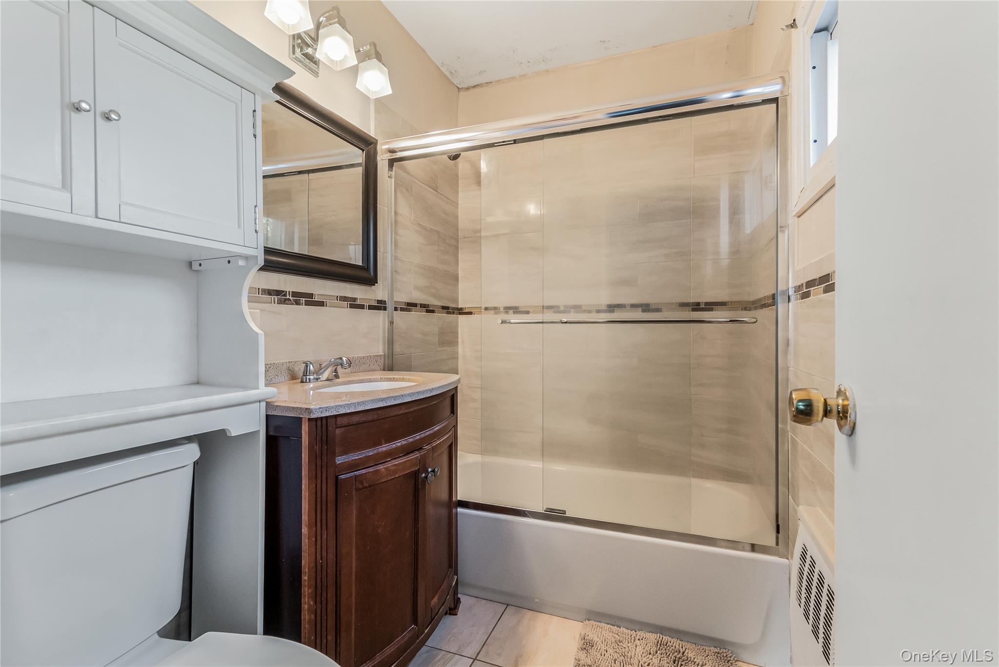 68 Riverdale Road Valley Stream, NY 11581 - Photo 12 of 19 a bathroom with a sink and a mirror