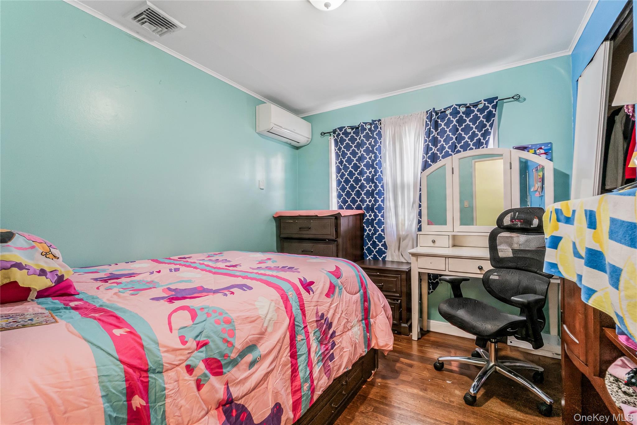 68 Riverdale Road Valley Stream, NY 11581 - Photo 10 of 19 a bedroom with a bed and a chair