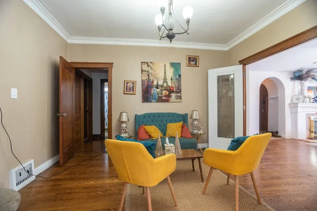a view of a dining room with furniture and a chandelier