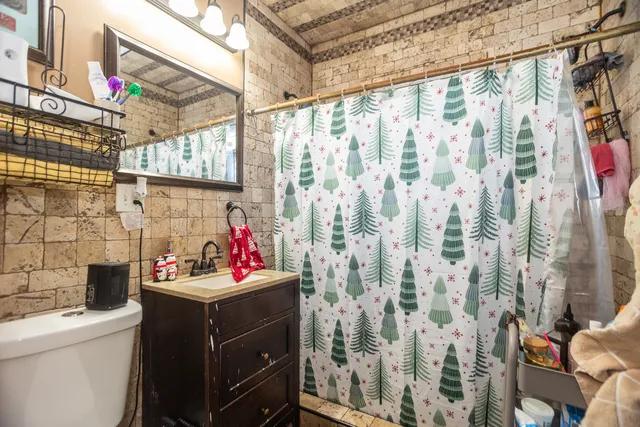 a bathroom with a sink toilet and shower
