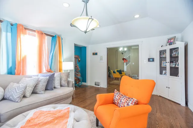 a living room with furniture and a chandelier