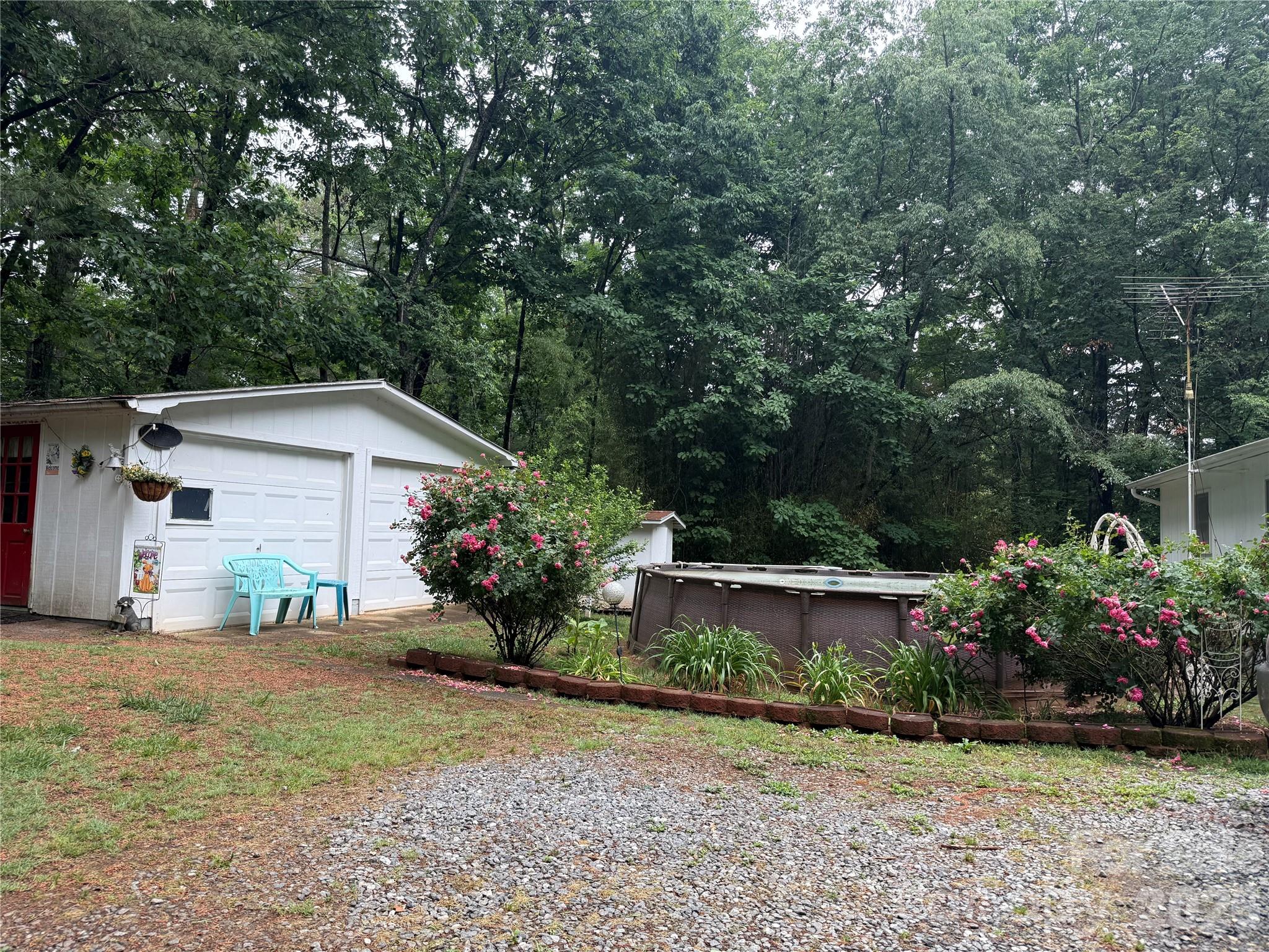 580 Legion Road Lenoir, NC 28645 - Photo 3 of 22 a view of a house with garden and plants