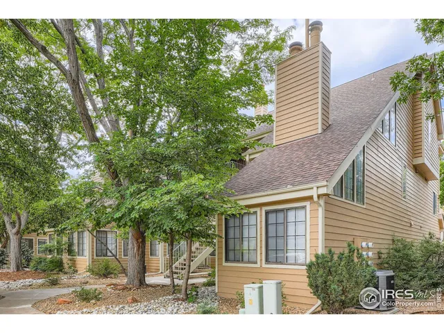 a view of a house with a yard and potted plants
