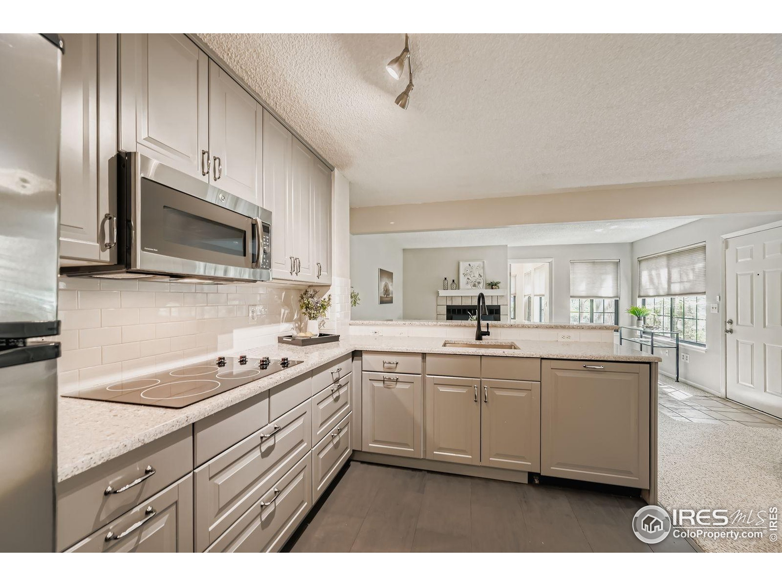 4767 White Rock Circle, Unit D Boulder, CO 80301 - Photo 16 of 41 a kitchen with stainless steel appliances a sink stove and microwave