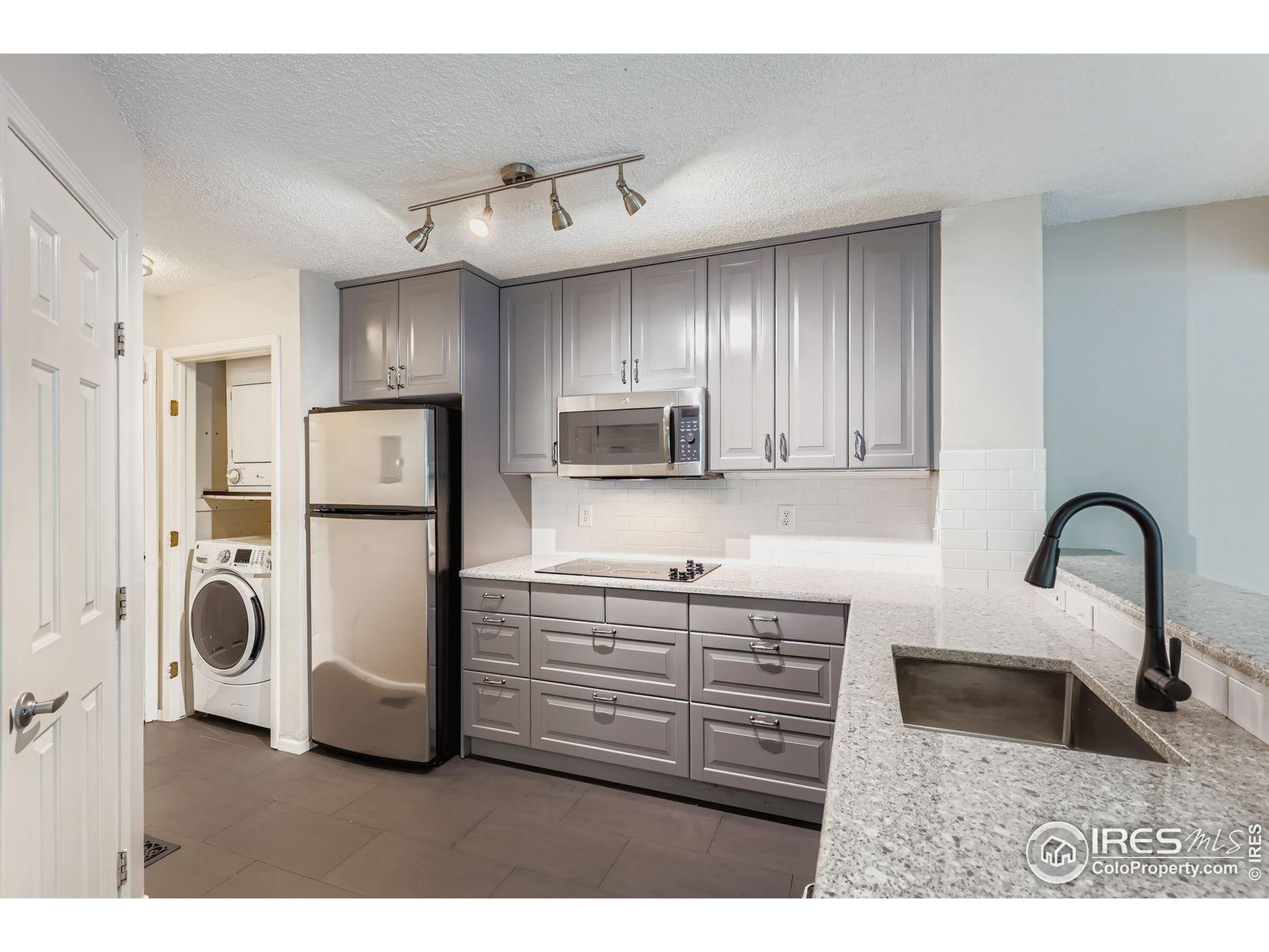 4767 White Rock Circle, Unit D Boulder, CO 80301 - Photo 18 of 41 a kitchen with refrigerator and cabinets