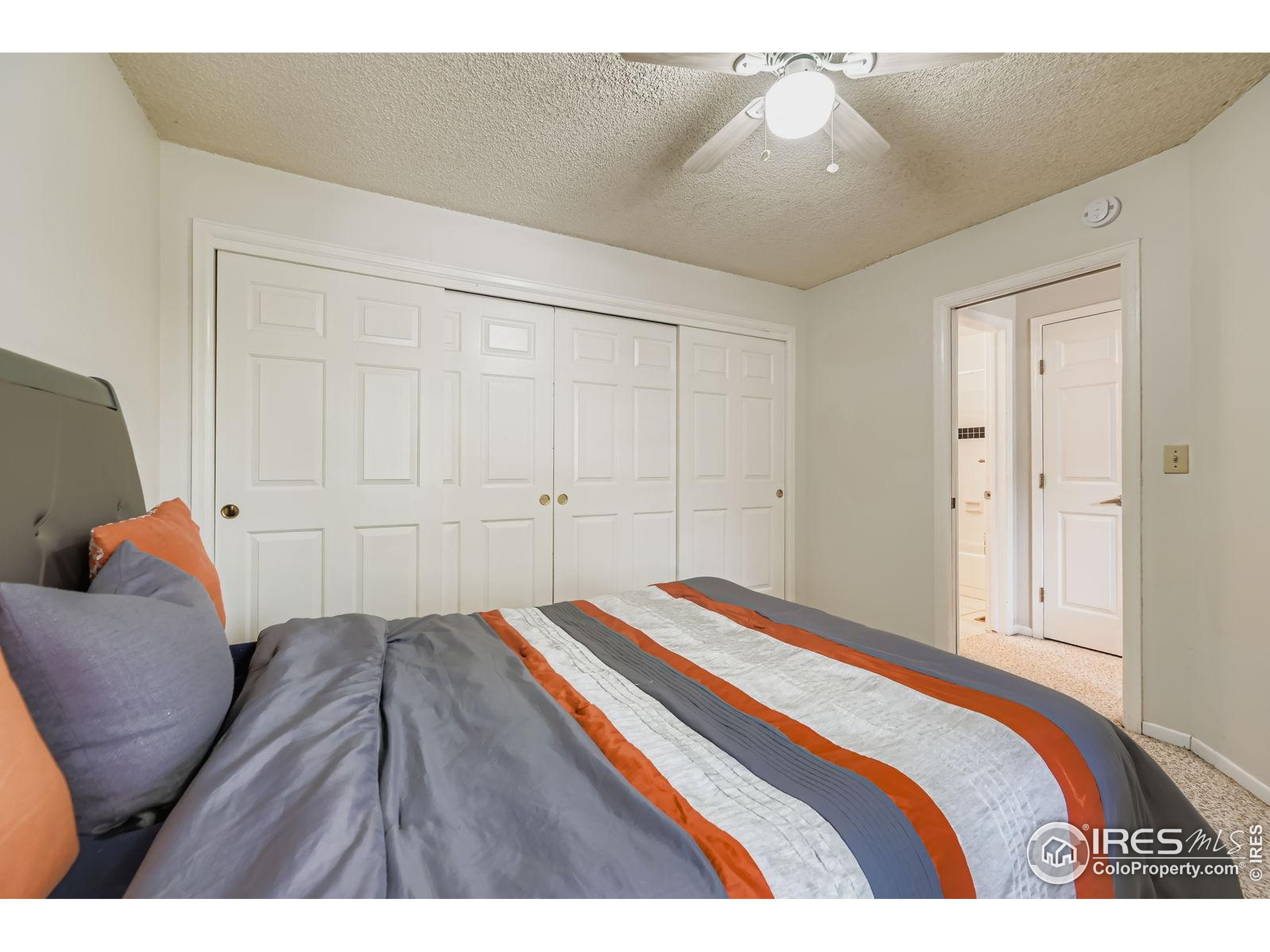 4767 White Rock Circle, Unit D Boulder, CO 80301 - Photo 22 of 41 a bedroom with a bed and chair