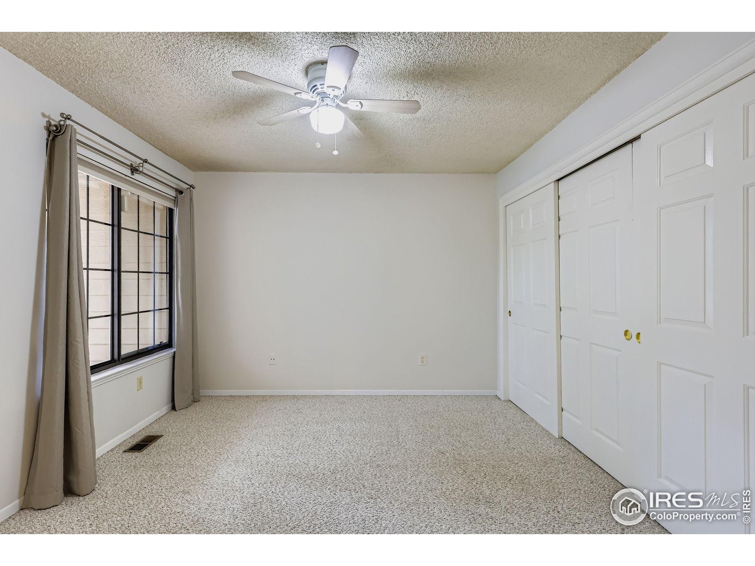 4767 White Rock Circle, Unit D Boulder, CO 80301 - Photo 24 of 41 an empty room with windows and chandelier fan