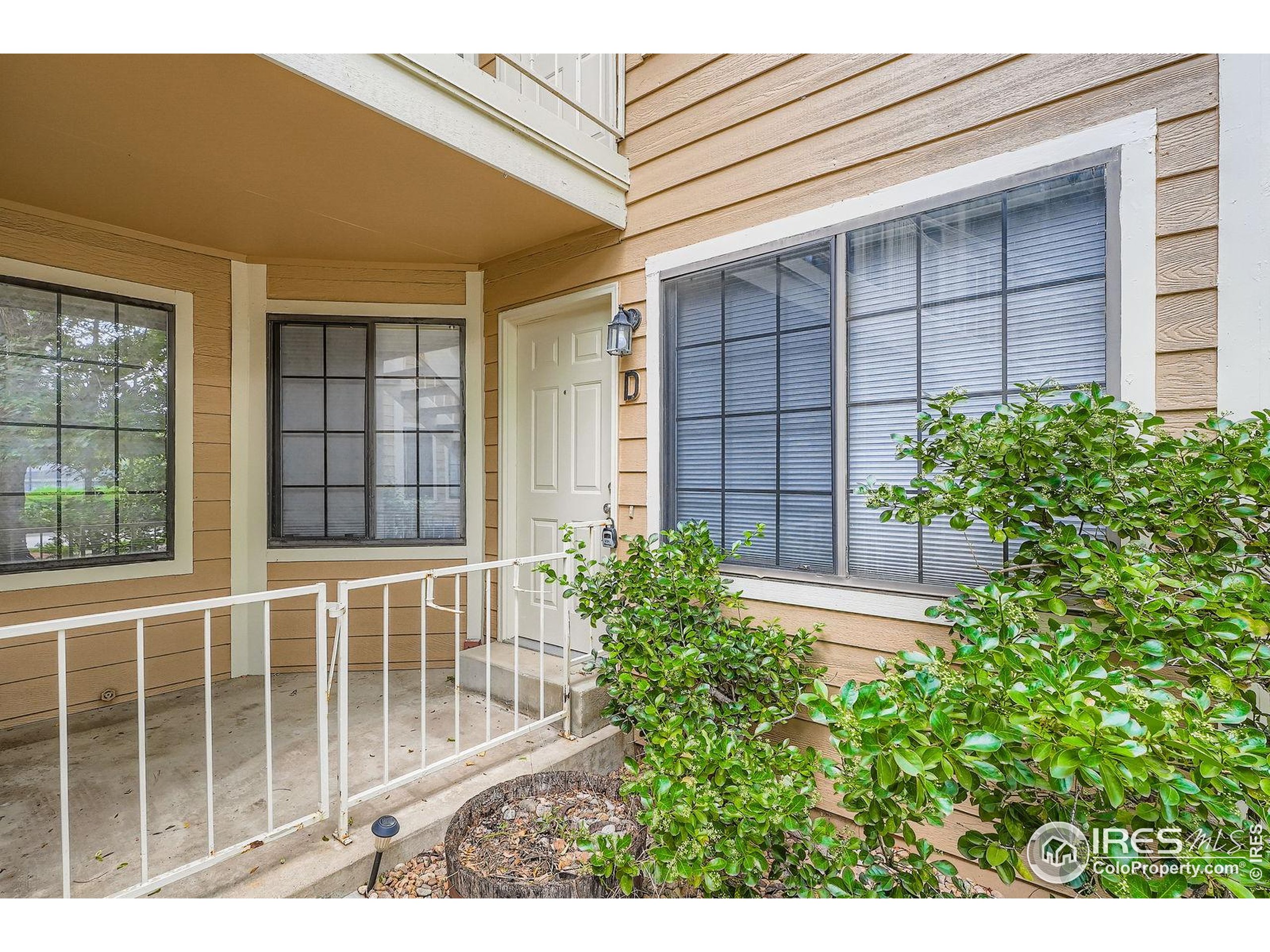 4767 White Rock Circle, Unit D Boulder, CO 80301 - Photo 5 of 41 a view of a house with a flower plants and wooden fence