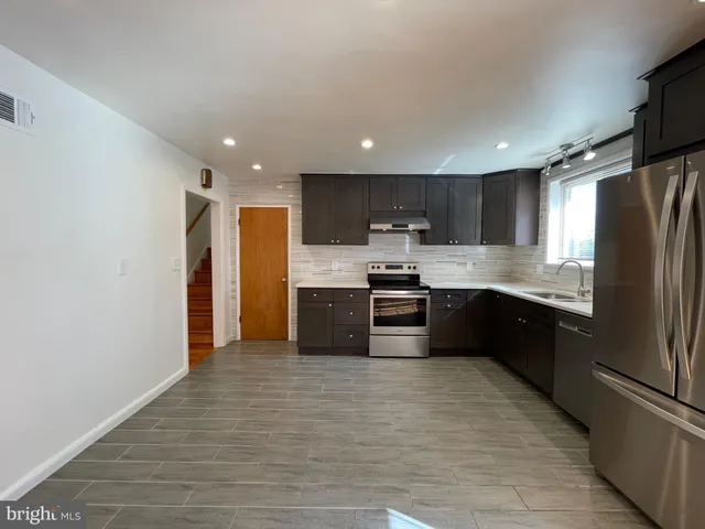 a kitchen with stainless steel appliances a refrigerator and a stove