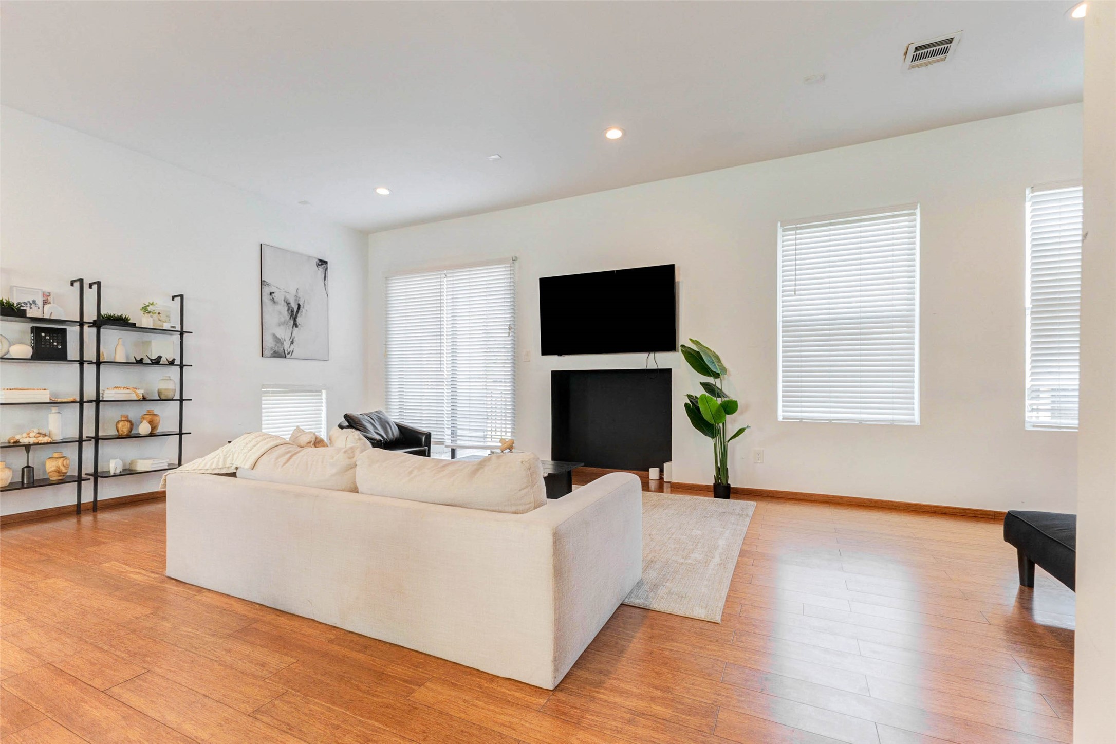 4115 Chartres Street Houston, TX 77004 - Photo 13 of 50 a living room with furniture a flat screen tv and a fireplace