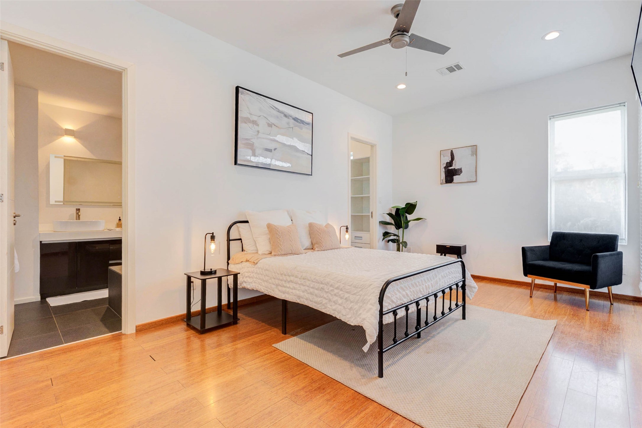 4115 Chartres Street Houston, TX 77004 - Photo 31 of 50 a bedroom with a bed a couch and a flat screen tv