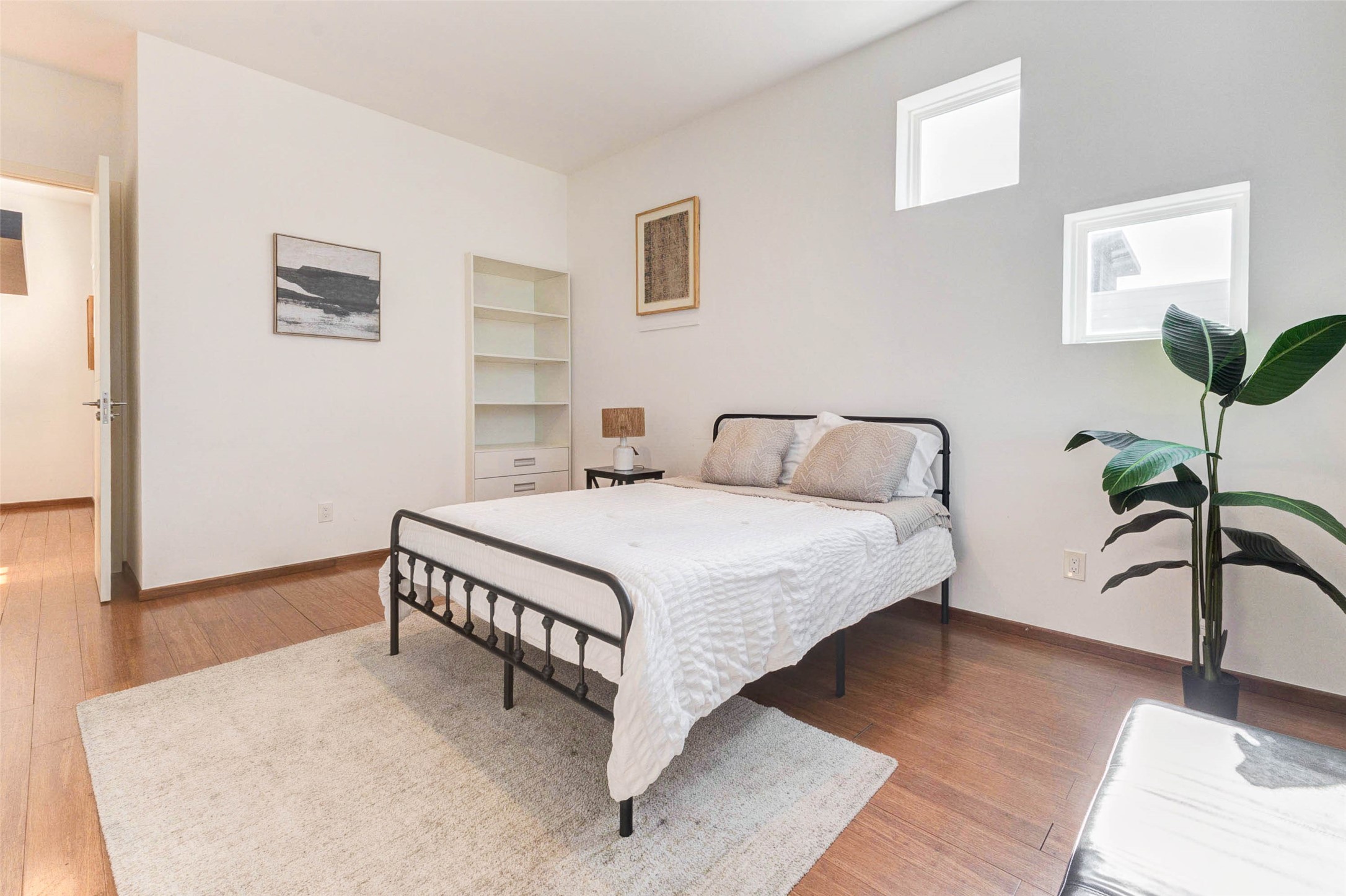 4115 Chartres Street Houston, TX 77004 - Photo 44 of 50 a bedroom with a bed and a potted plant on the dresser