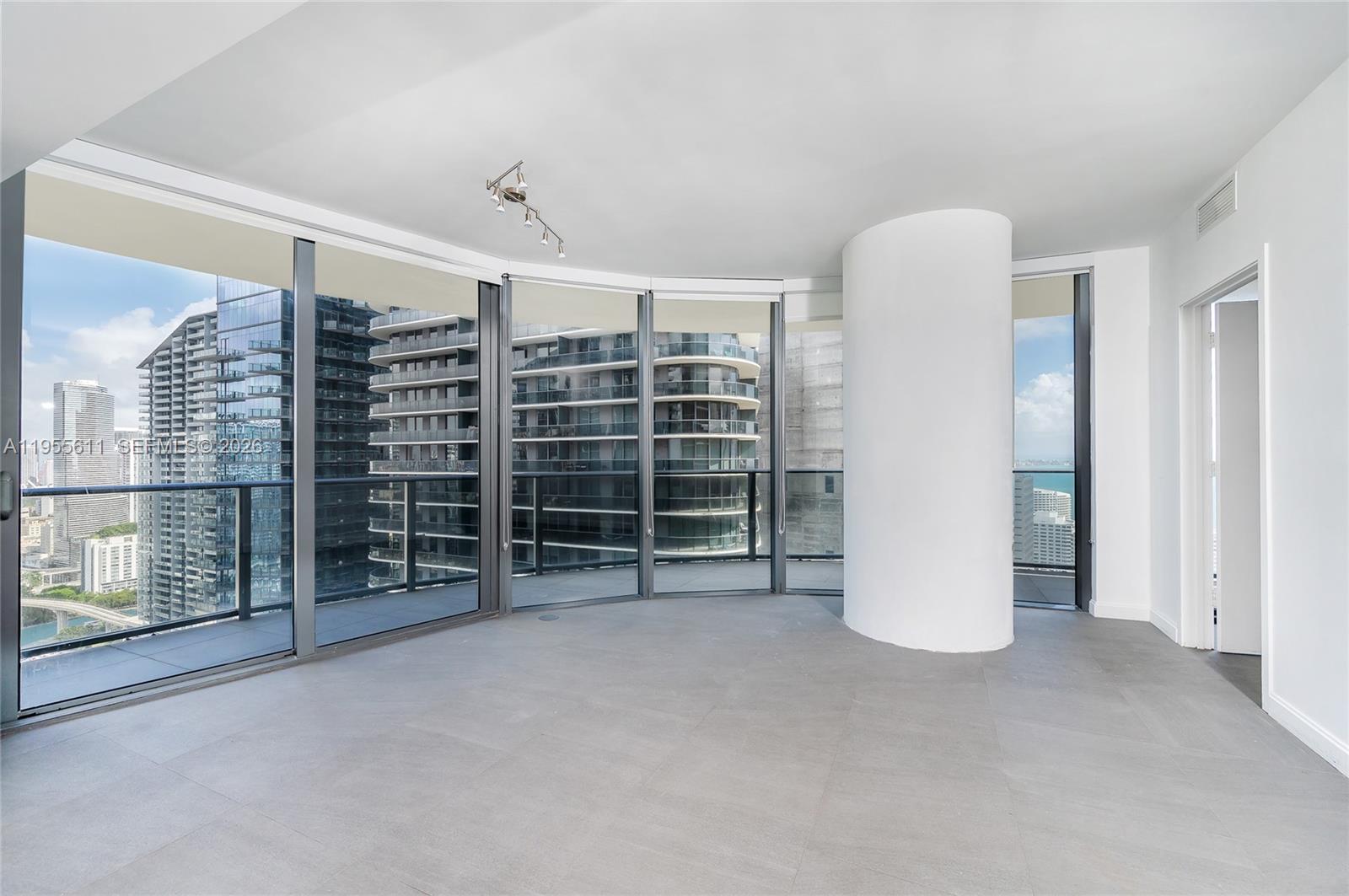 45 Southwest 9th Street, Unit 3401 Miami, FL 33130 - Photo 2 of 36 a view of an empty room with a fireplace and entryway