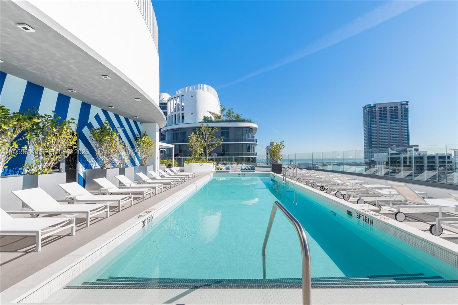 45 Southwest 9th Street, Unit 3401 Miami, FL 33130 - Photo 27 of 36 a view of a kitchen with kitchen island and the counter top