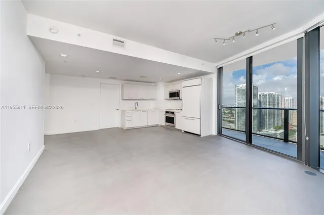 a kitchen with white cabinets and white appliances