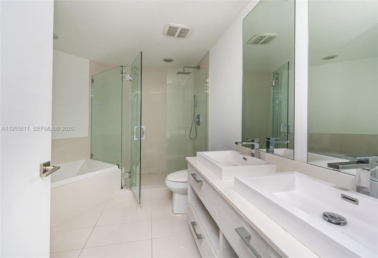 45 Southwest 9th Street, Unit 3401 Miami, FL 33130 - Photo 8 of 36 a bathroom with a sink a toilet and shower