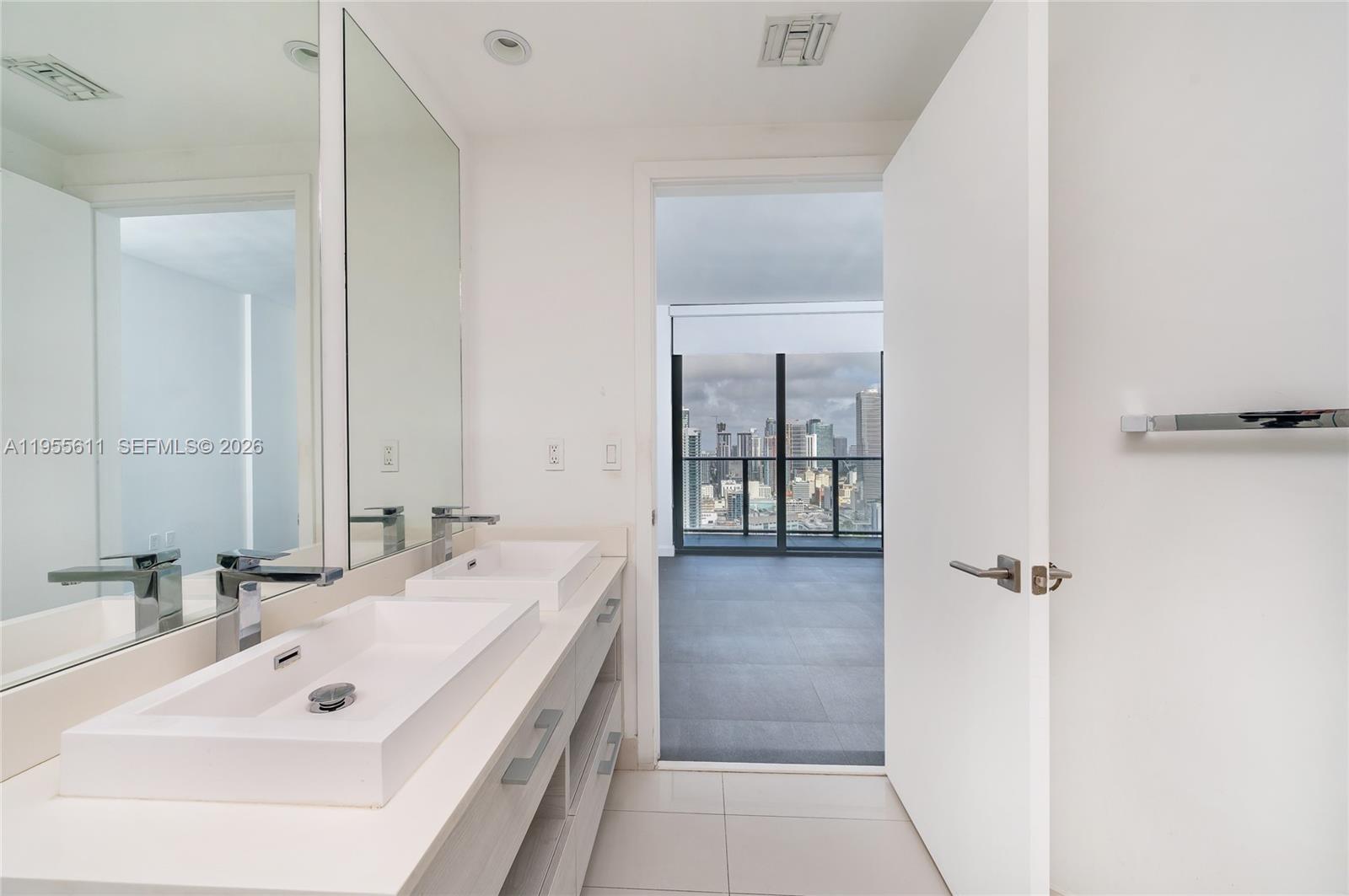 45 Southwest 9th Street, Unit 3401 Miami, FL 33130 - Photo 9 of 36 a bathroom with a tub sink and mirror