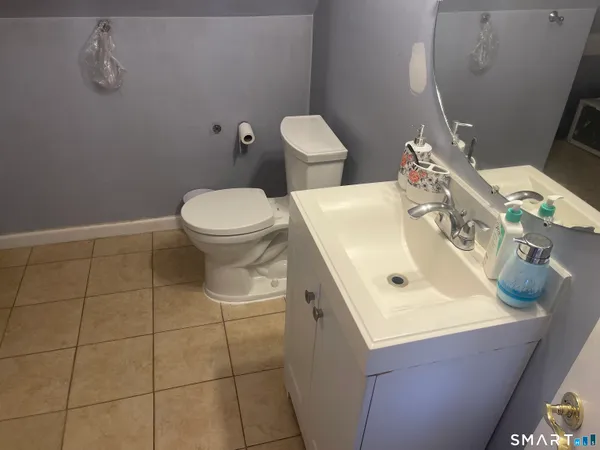 a bathroom with a sink toilet and mirror