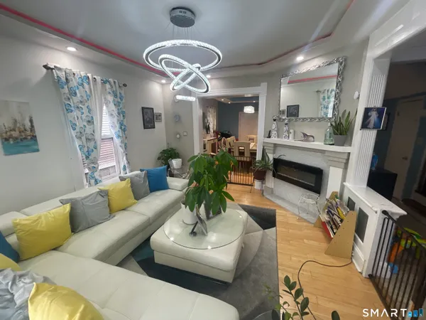 a living room with furniture flat screen tv and a fireplace