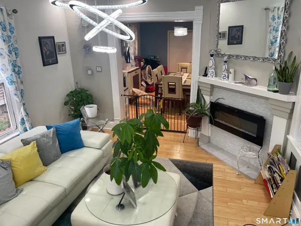 a living room with furniture and a mirror