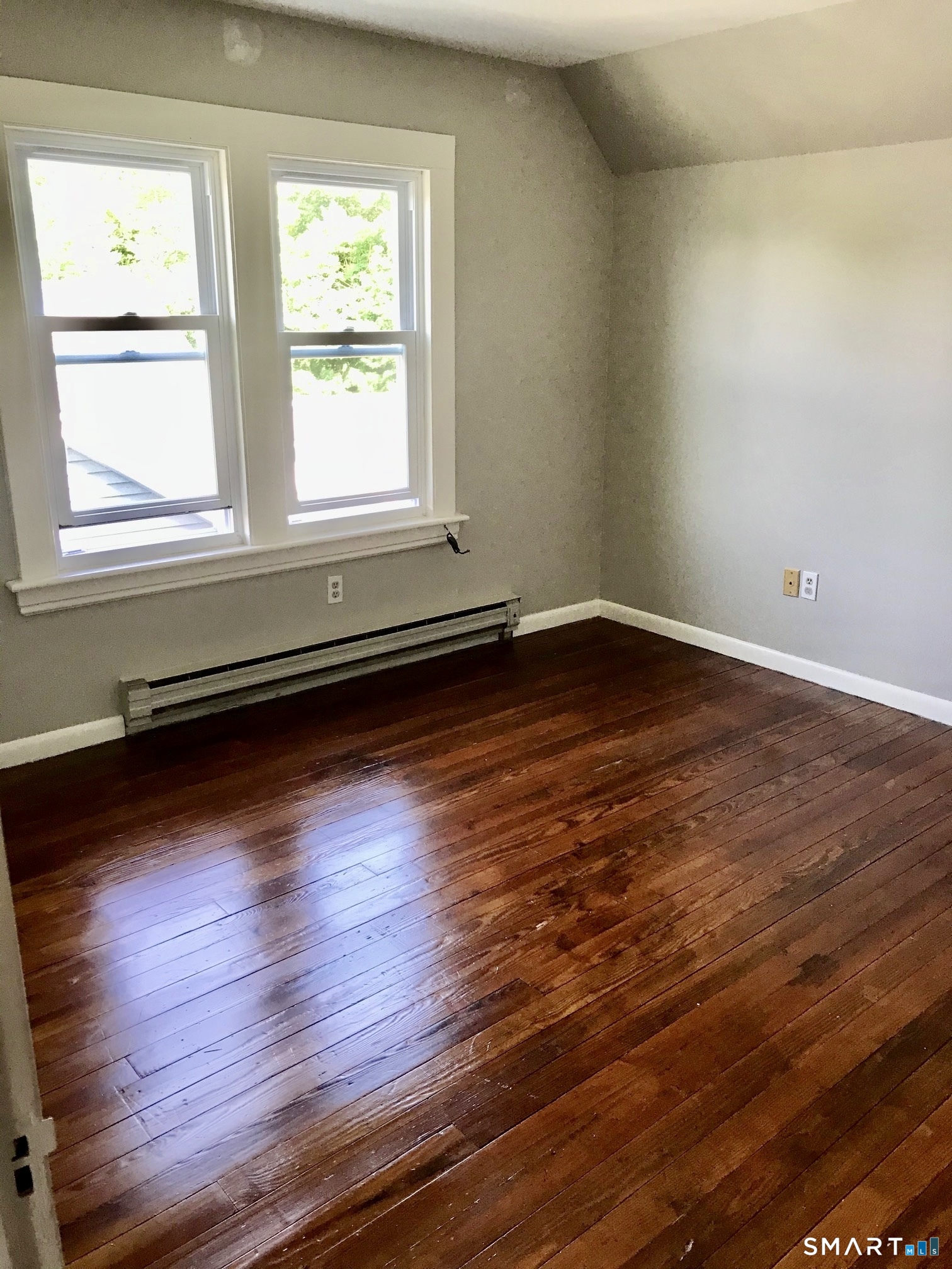 52 Catherine Street Stratford, CT 06615 - Photo 11 of 19 a view of an empty room with wooden floor and a window