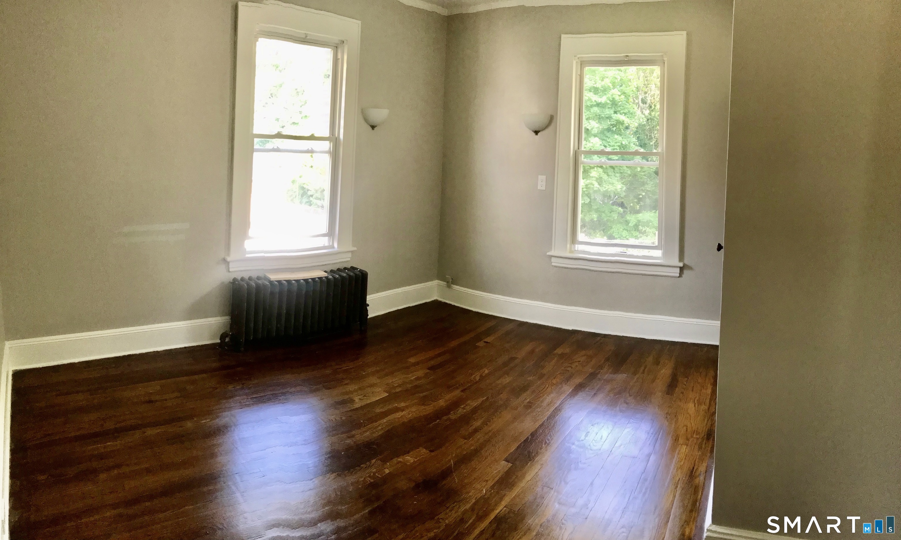 52 Catherine Street Stratford, CT 06615 - Photo 14 of 19 an empty room with wooden floor and windows