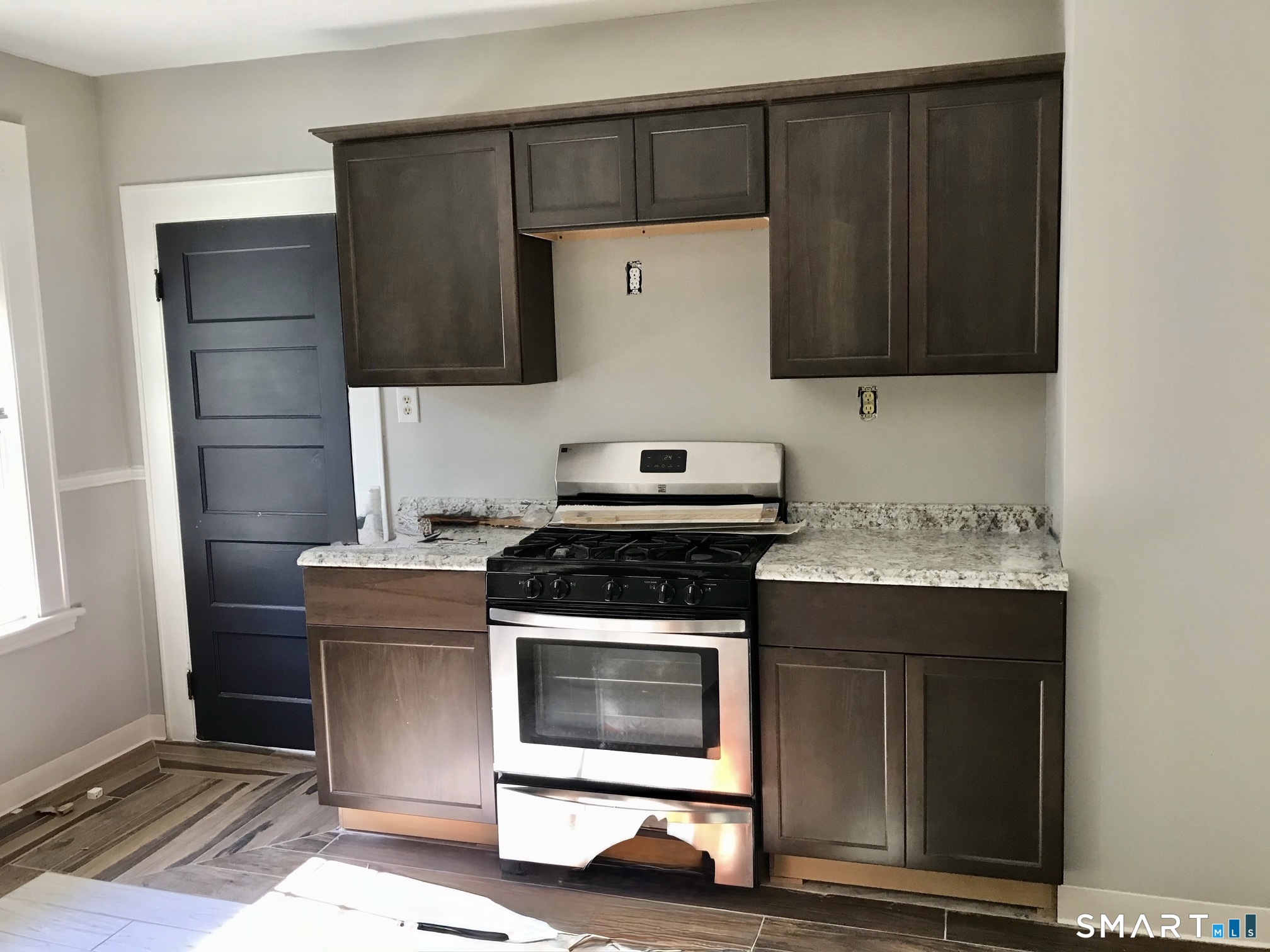 52 Catherine Street Stratford, CT 06615 - Photo 3 of 19 a kitchen with a stove and a microwave