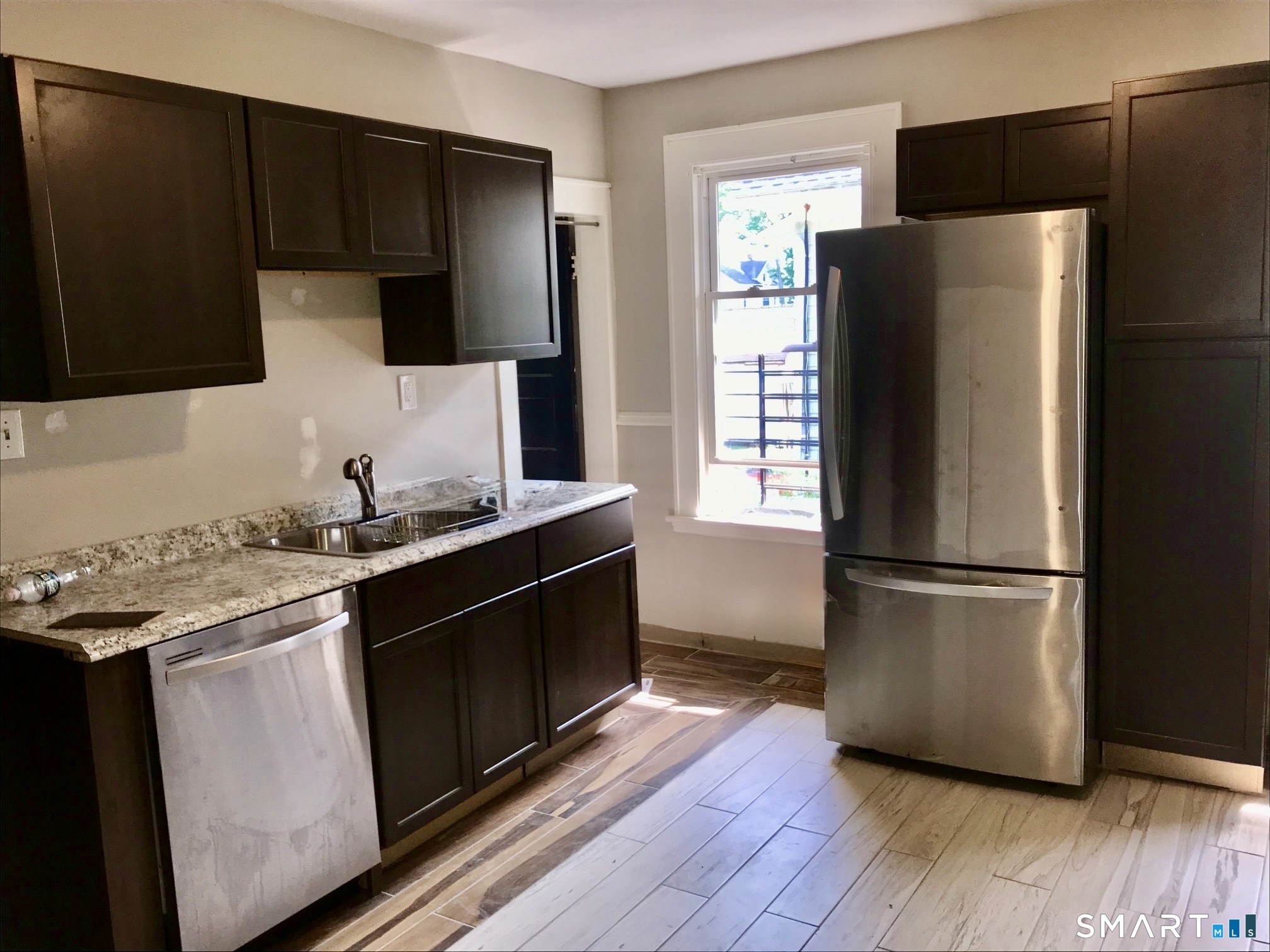 52 Catherine Street Stratford, CT 06615 - Photo 4 of 19 a kitchen with stainless steel appliances a refrigerator stove and sink