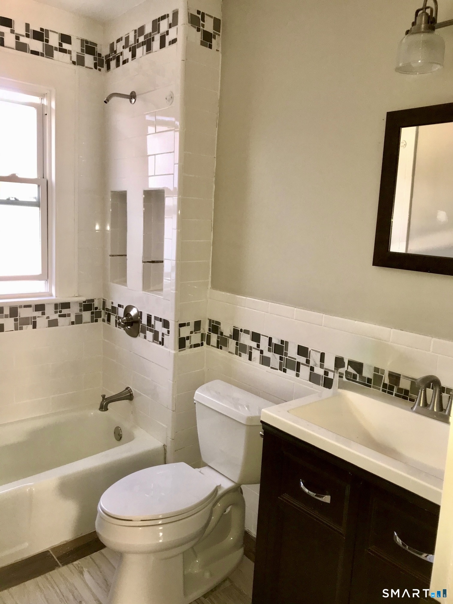 52 Catherine Street Stratford, CT 06615 - Photo 6 of 19 a bathroom with a sink a toilet a mirror a vanity and bathtub