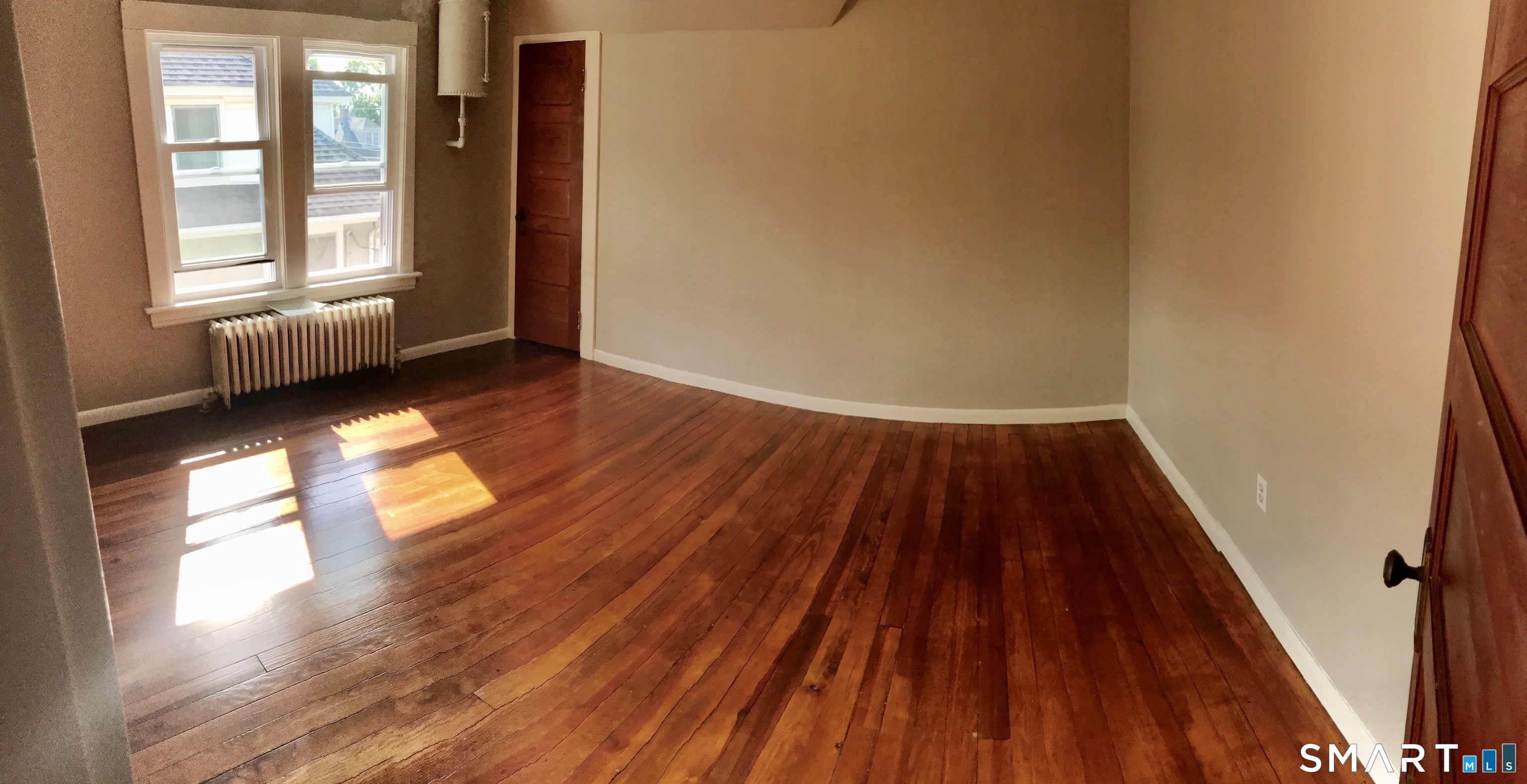 52 Catherine Street Stratford, CT 06615 - Photo 10 of 19 a view of empty room with wooden floor and fan