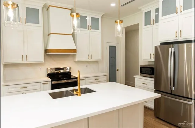 a kitchen with a refrigerator and a stove