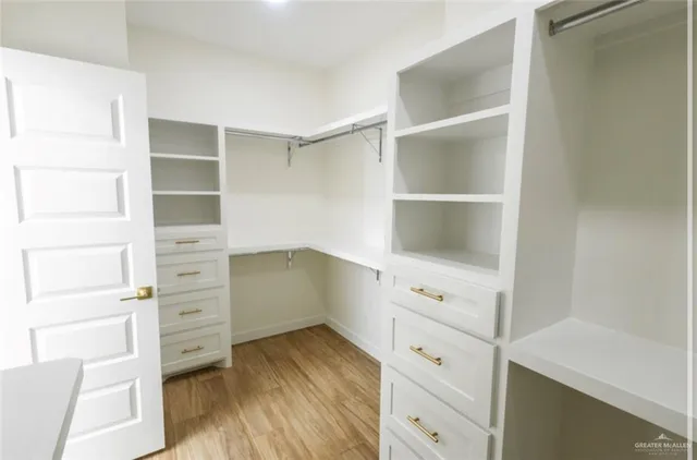 a view of a kitchen with a sink and a refrigerator