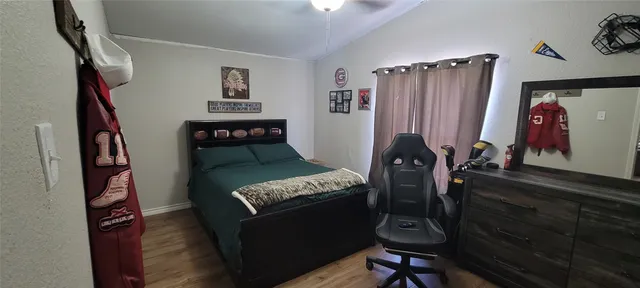 a bedroom with furniture and a window