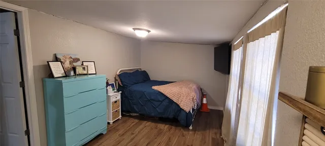 a room with a dresser and wooden floor
