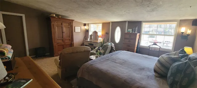 a bedroom with two beds and wooden floor