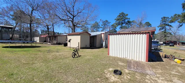 a view of a backyard with a tree