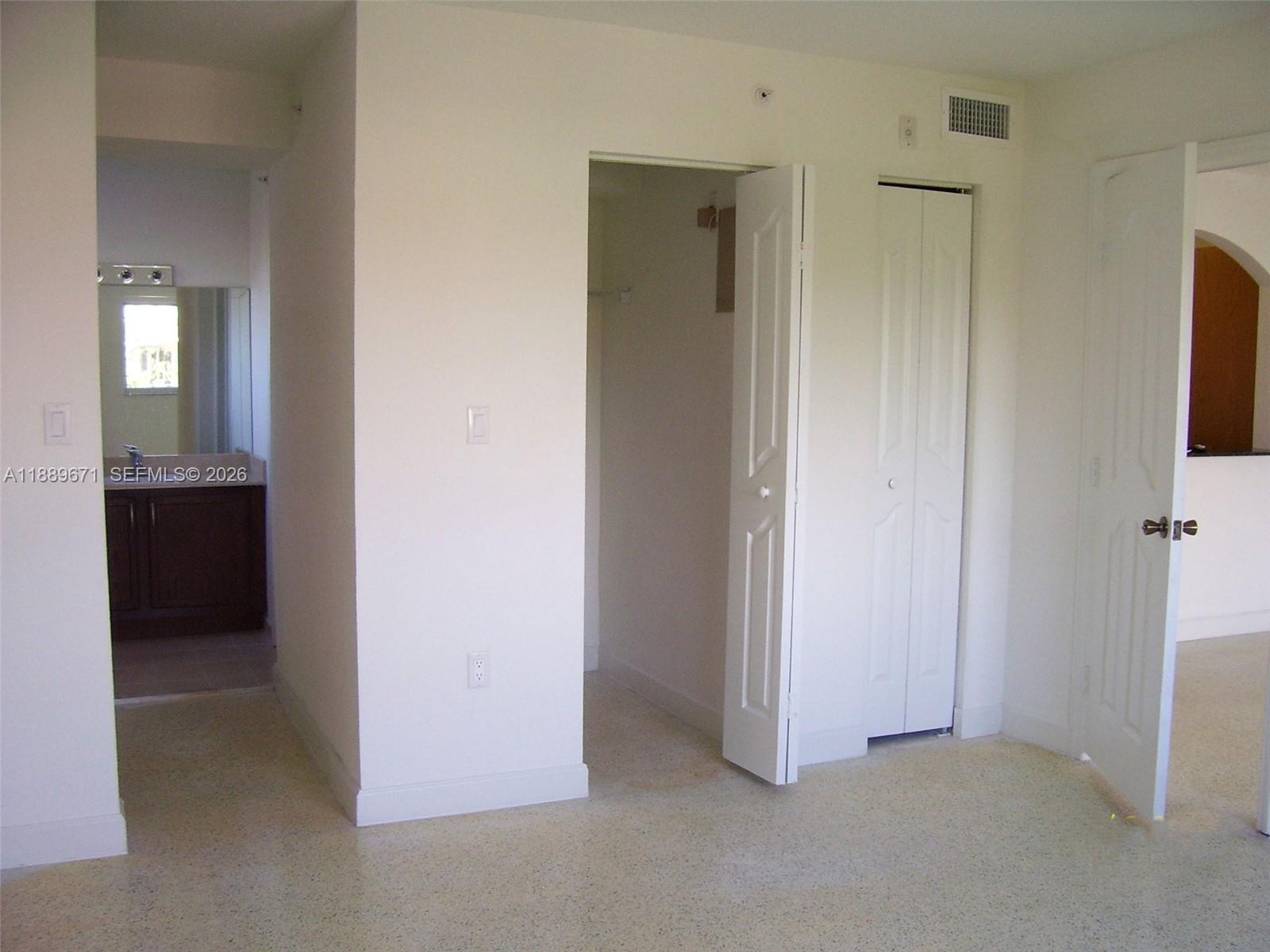 445 Southwest 11th Street, Unit 203 Miami, FL 33130 - Photo 2 of 18 a view of an empty room with a bathroom