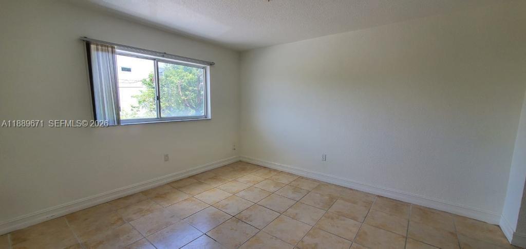 445 Southwest 11th Street, Unit 203 Miami, FL 33130 - Photo 3 of 18 an empty room with a window