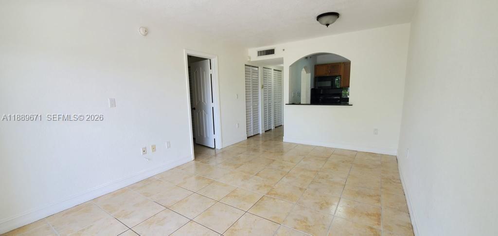 445 Southwest 11th Street, Unit 203 Miami, FL 33130 - Photo 9 of 18 an empty room with windows